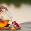 the hand of the girl pouring hot tea in the palm of the tea onto