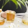 woman holding glass with tea honey dipper